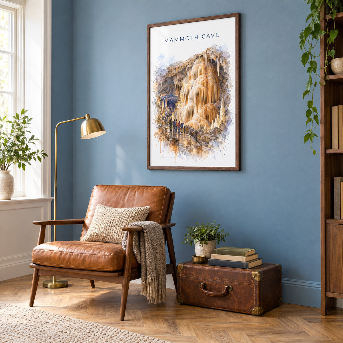 Mammoth Cave National Park watercolor print in a walnut frame on a blue wall above a leather armchair in a reading nook