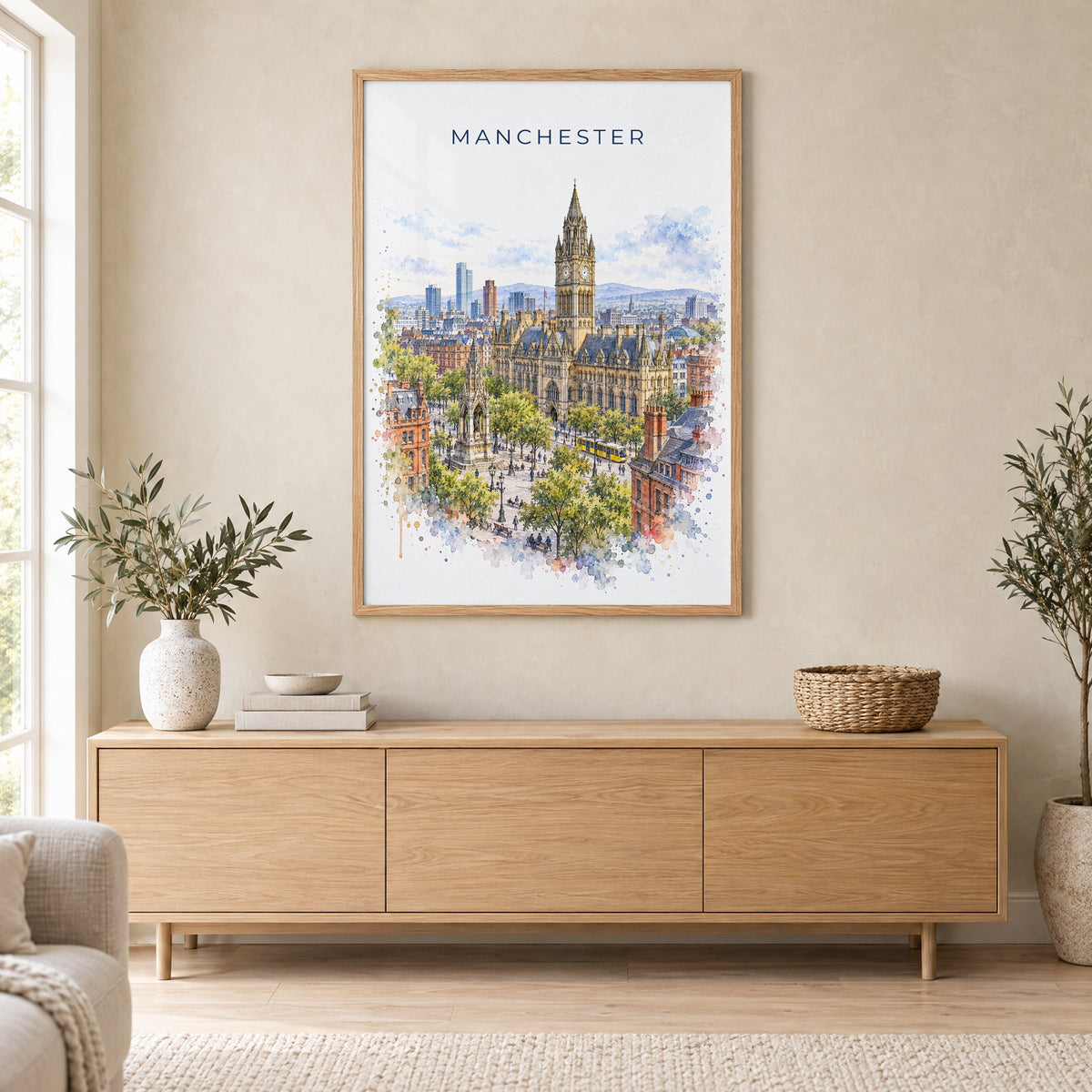 Manchester, England watercolor print in an oak frame above a light wood sideboard in a Scandinavian living room