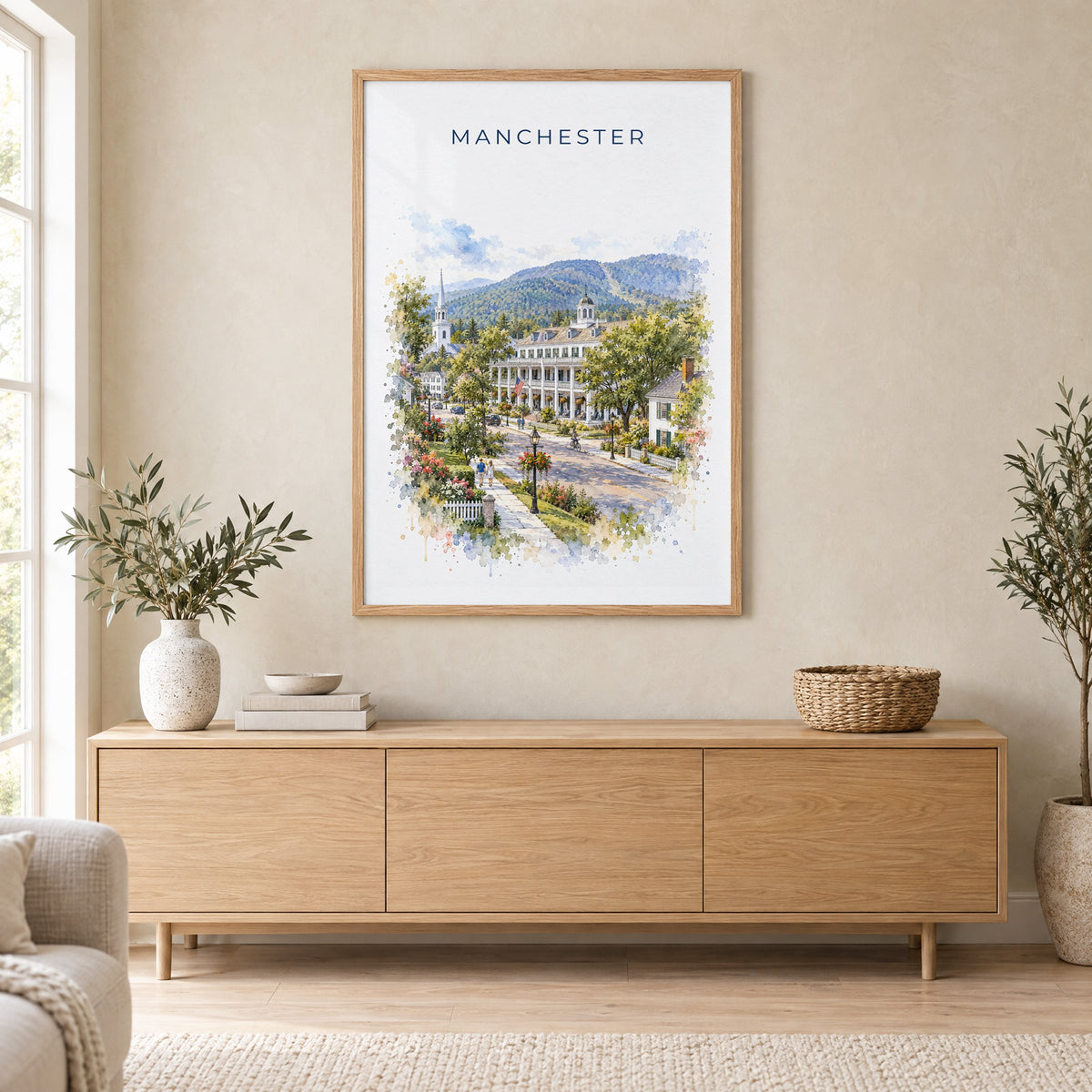 Manchester, Vermont watercolor print in an oak frame above a light wood sideboard in a Scandinavian living room