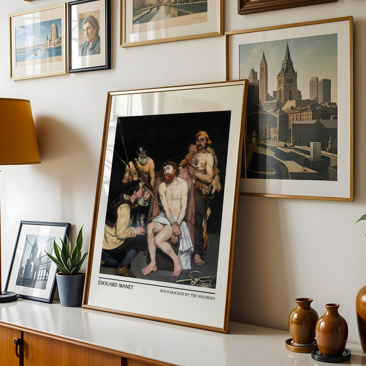 Dark old master scene shown in a gold frame leaning on a sideboard in a gallery wall