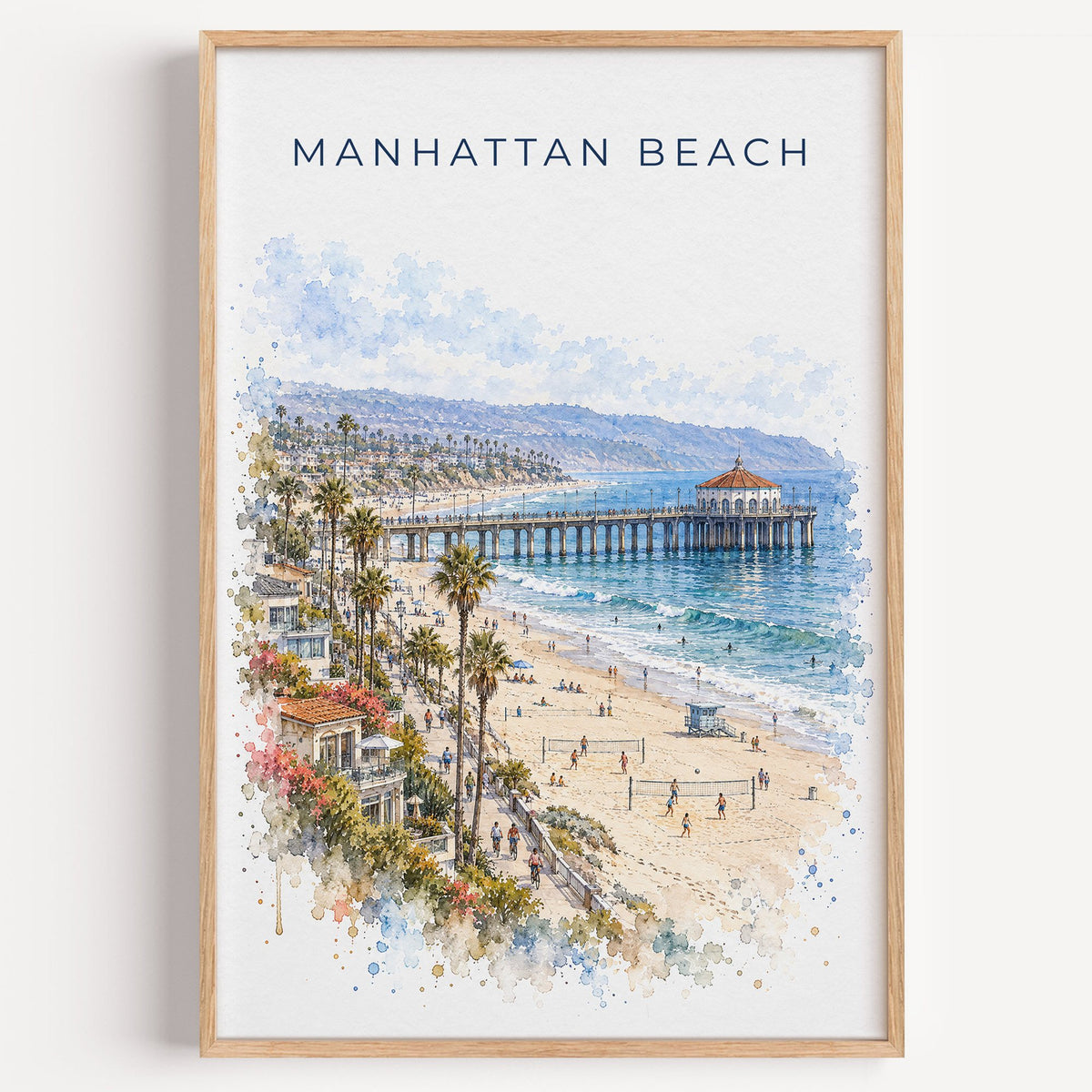 Manhattan Beach watercolor print in a light oak frame on a plain white wall