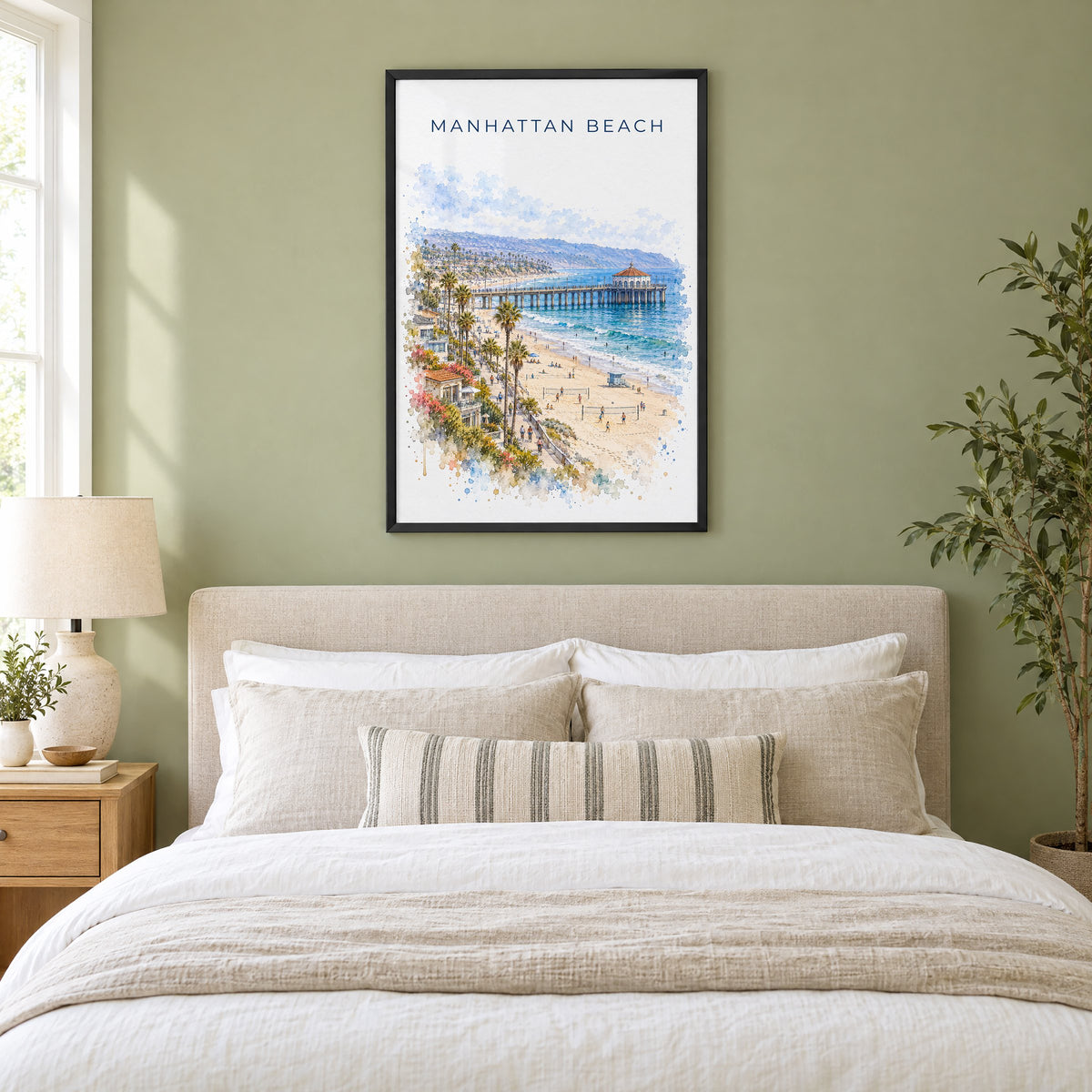 Manhattan Beach watercolor print in a black frame above an upholstered headboard in a sage green bedroom