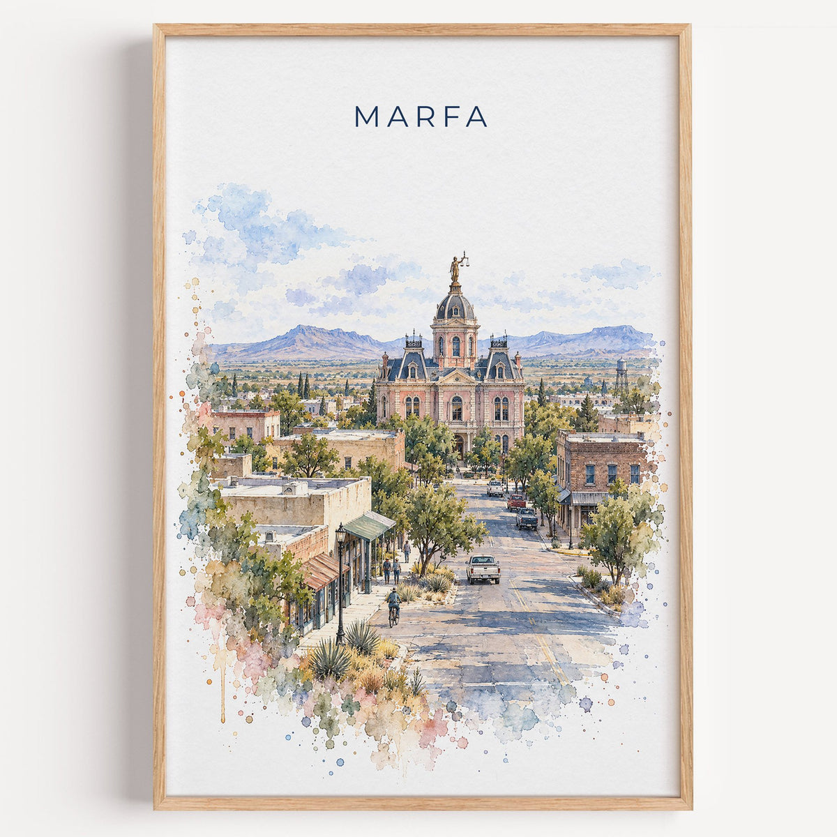 Marfa watercolor print in a light oak frame on a plain white wall