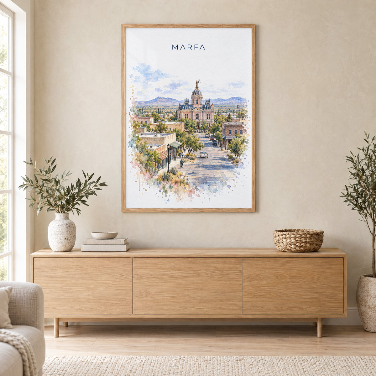 Marfa watercolor print in an oak frame above a light wood sideboard in a Scandinavian living room