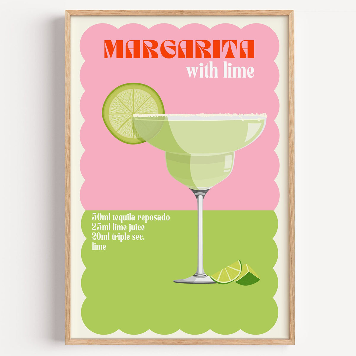 Margarita with lime scalloped print in a light oak frame on a plain white wall