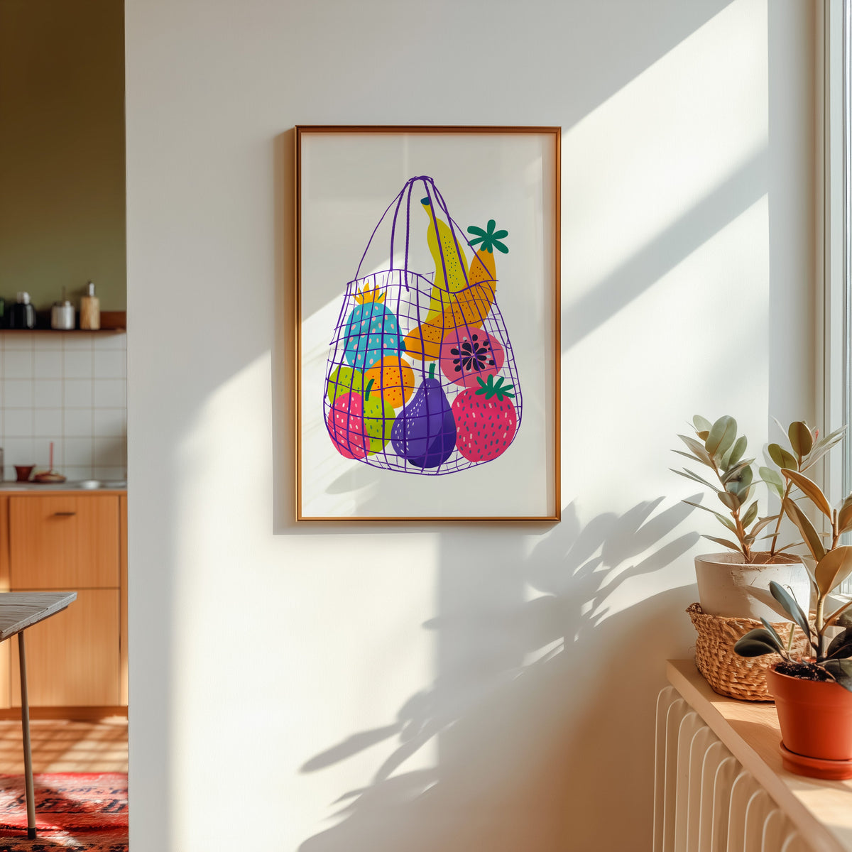Fruit market bag print in a gold frame in sunlight with plants and a kitchen beyond