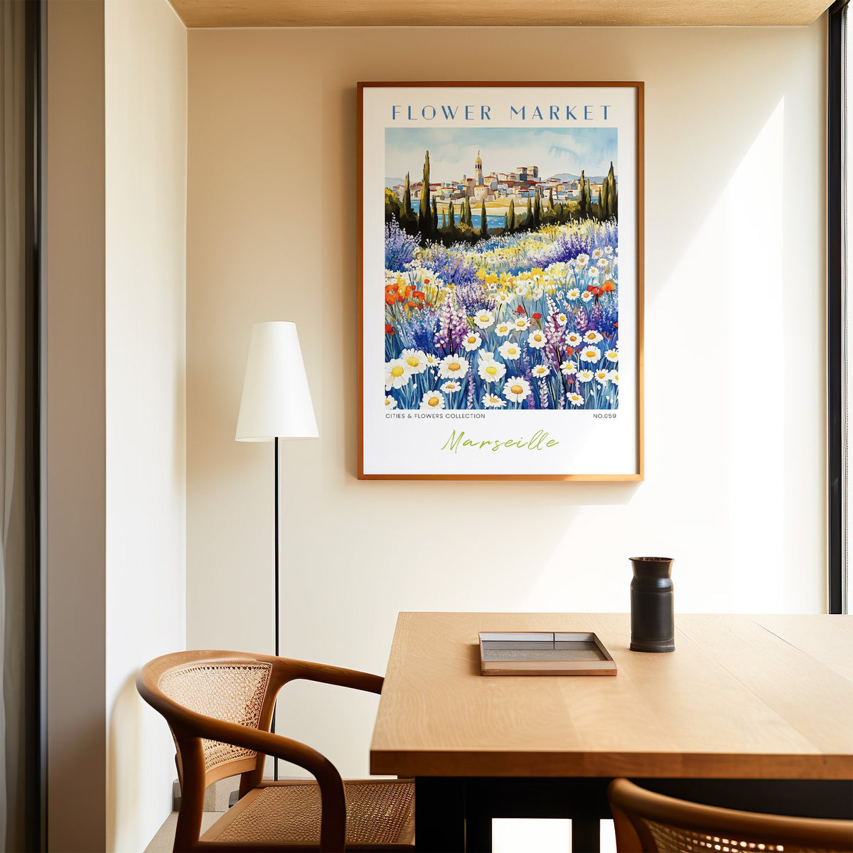 Marseille flower market print in an oak frame above a dining table and cane chair