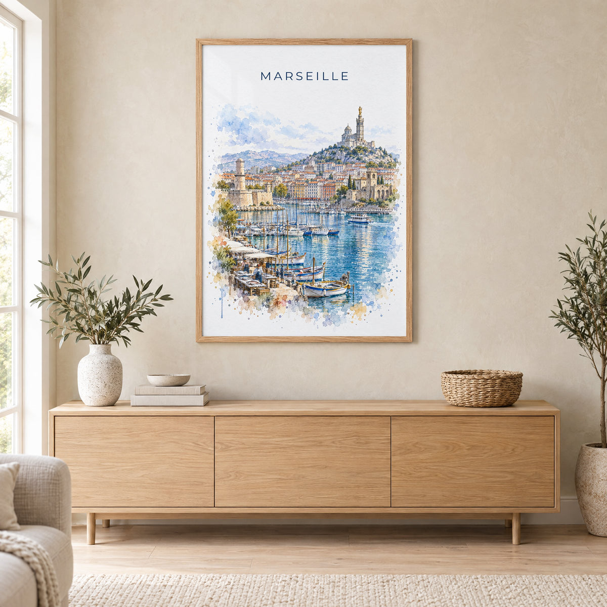 Marseille watercolor print in an oak frame above a light wood sideboard in a Scandinavian living room
