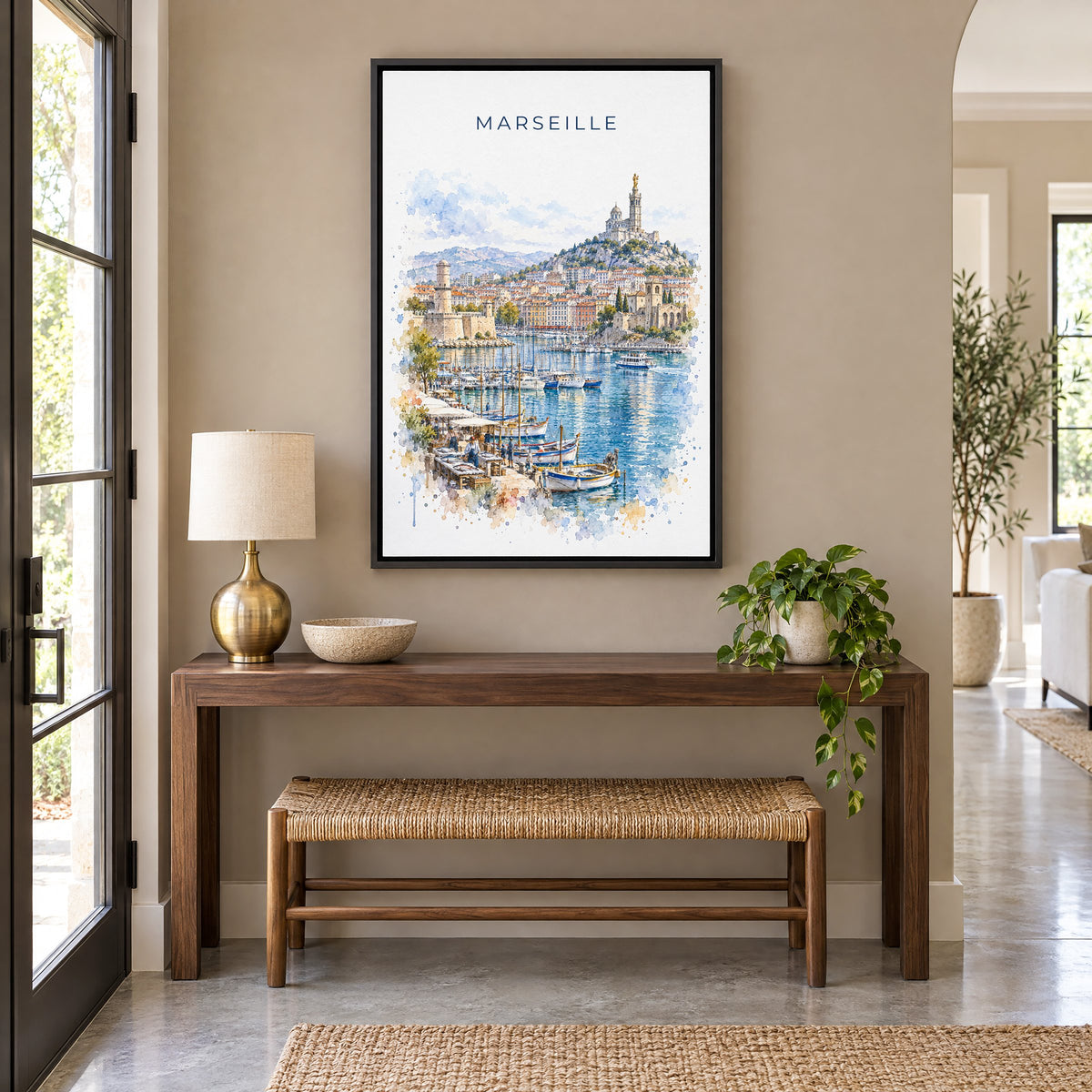 Marseille watercolor print as a black floater canvas above a walnut console and woven bench in an entryway
