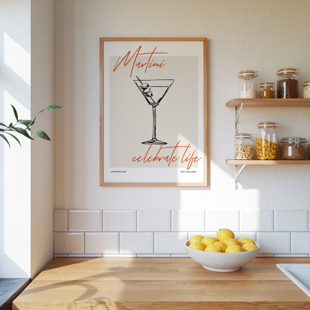 Martini Celebrate Life print in an oak frame beside open kitchen shelves