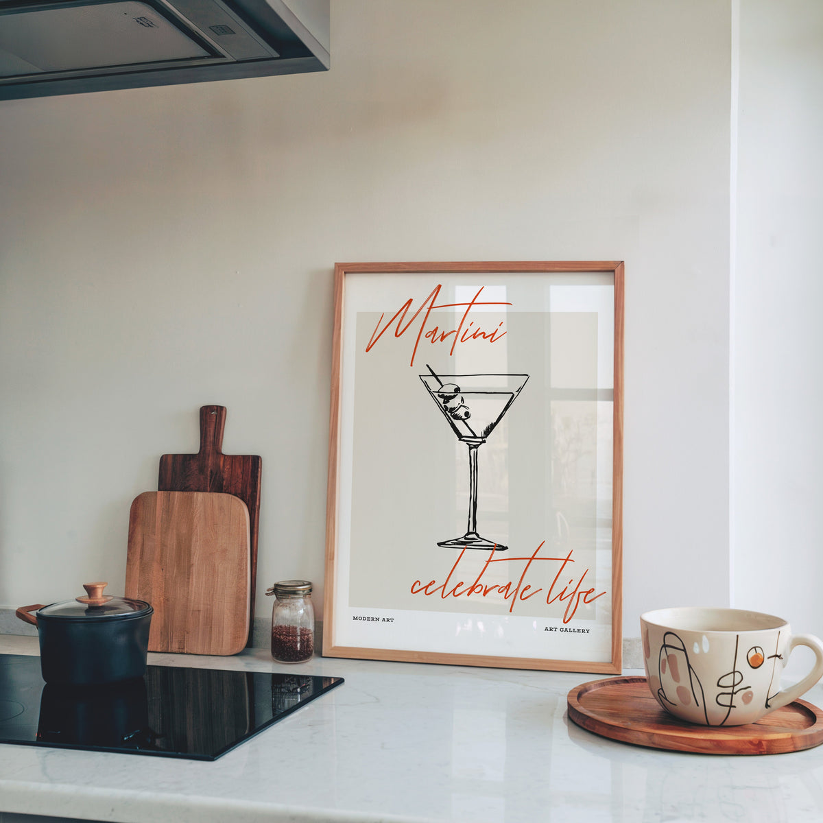 Martini Celebrate Life print in a pine frame on a marble kitchen counter
