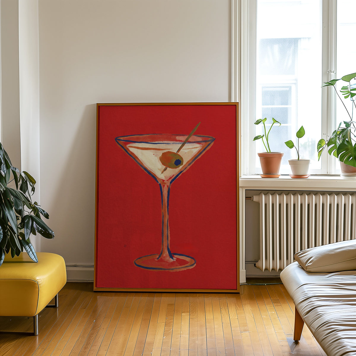 Olive martini print in an oak frame leaning beside a yellow leather bench