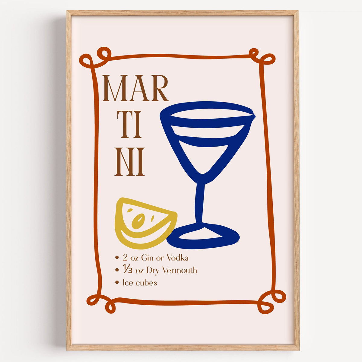 MARTINI recipe navy glass lemon print in a light oak frame on a plain white wall