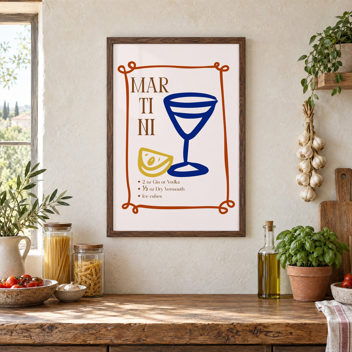 MARTINI recipe navy glass lemon print in a walnut frame above a rustic Italian pantry counter with pasta jars, garlic and tomatoes