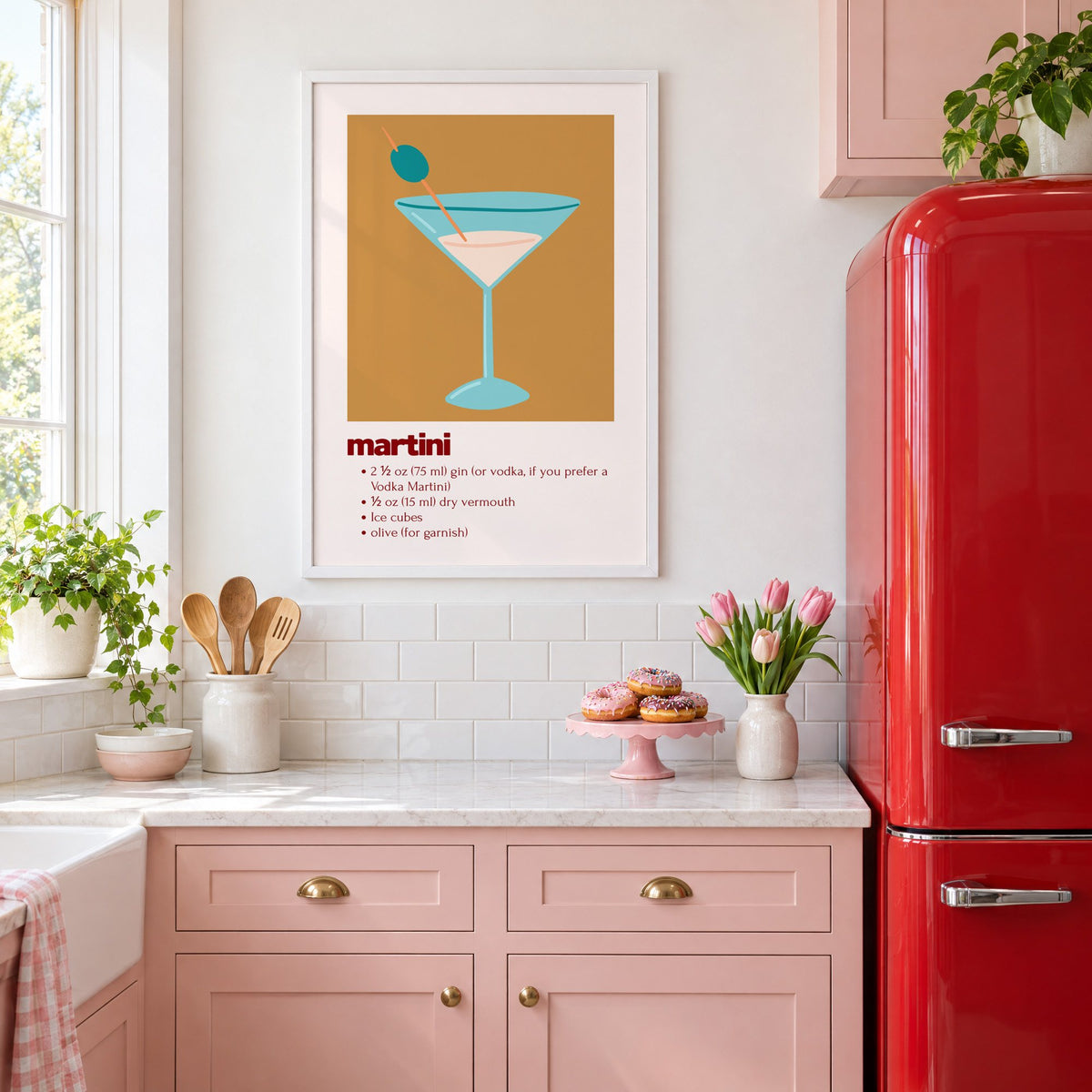 martini recipe olive glass ochre card print in a white frame above pink cabinets beside a red retro fridge
