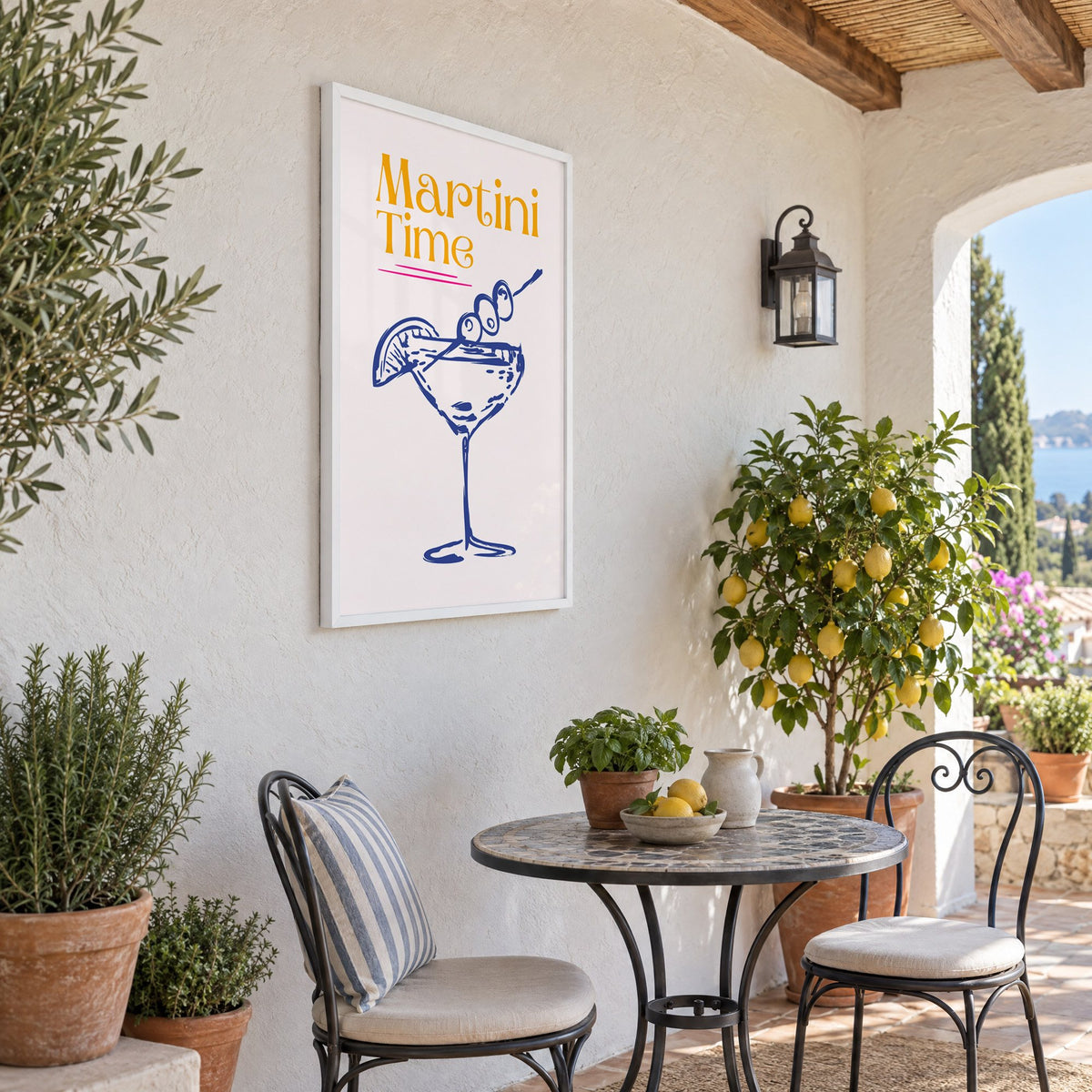Martini Time blue sketch print in a white frame on a sunny patio wall beside a potted lemon tree