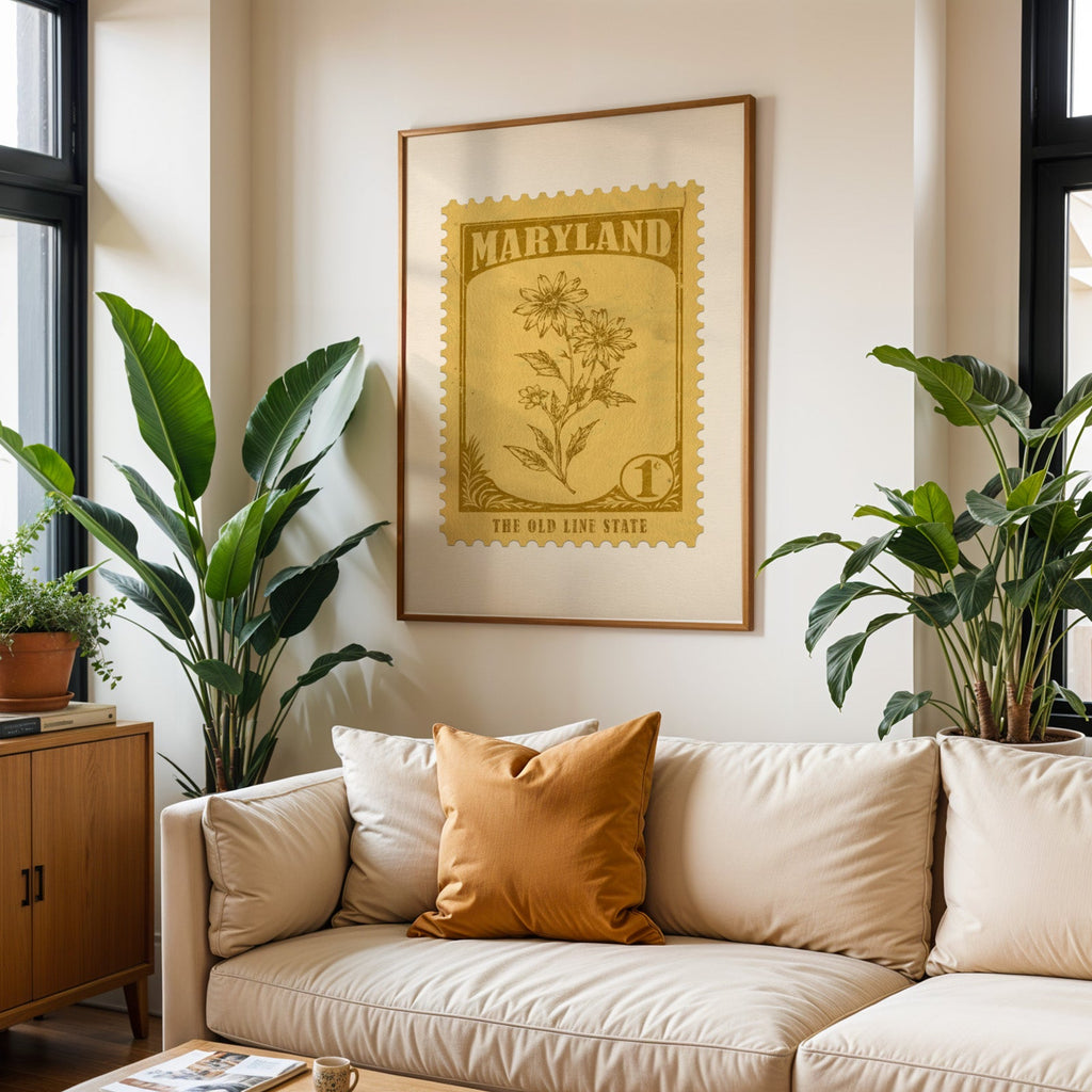 Maryland state flower print framed above a cream sofa with an ochre cushion and large plants either side