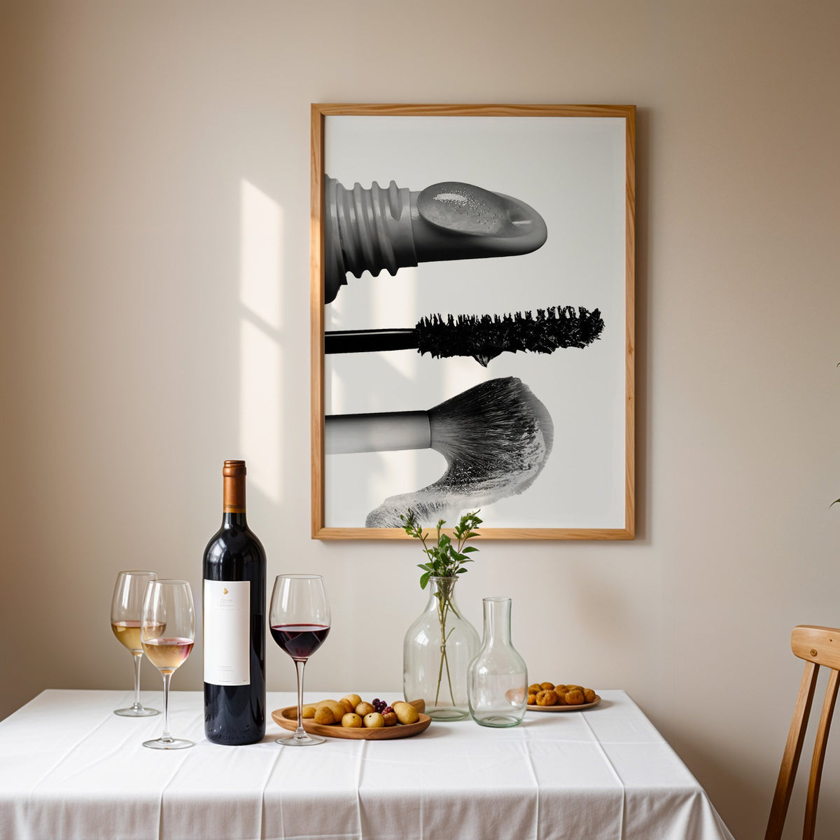 Macro gloss wand, mascara and blush brush print in an oak frame above a table set with red wine and glasses