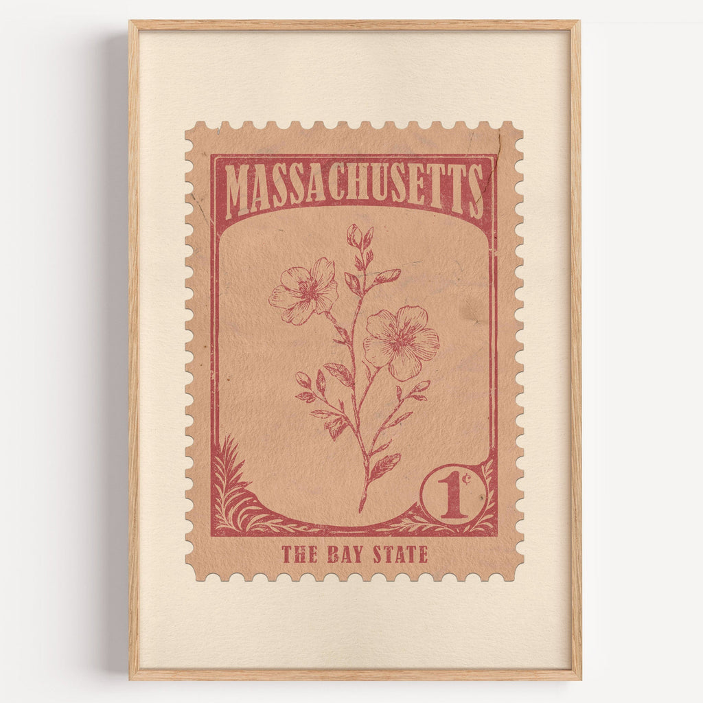 Massachusetts state flower stamp print in dusty rose on blush, light oak frame on a plain white wall