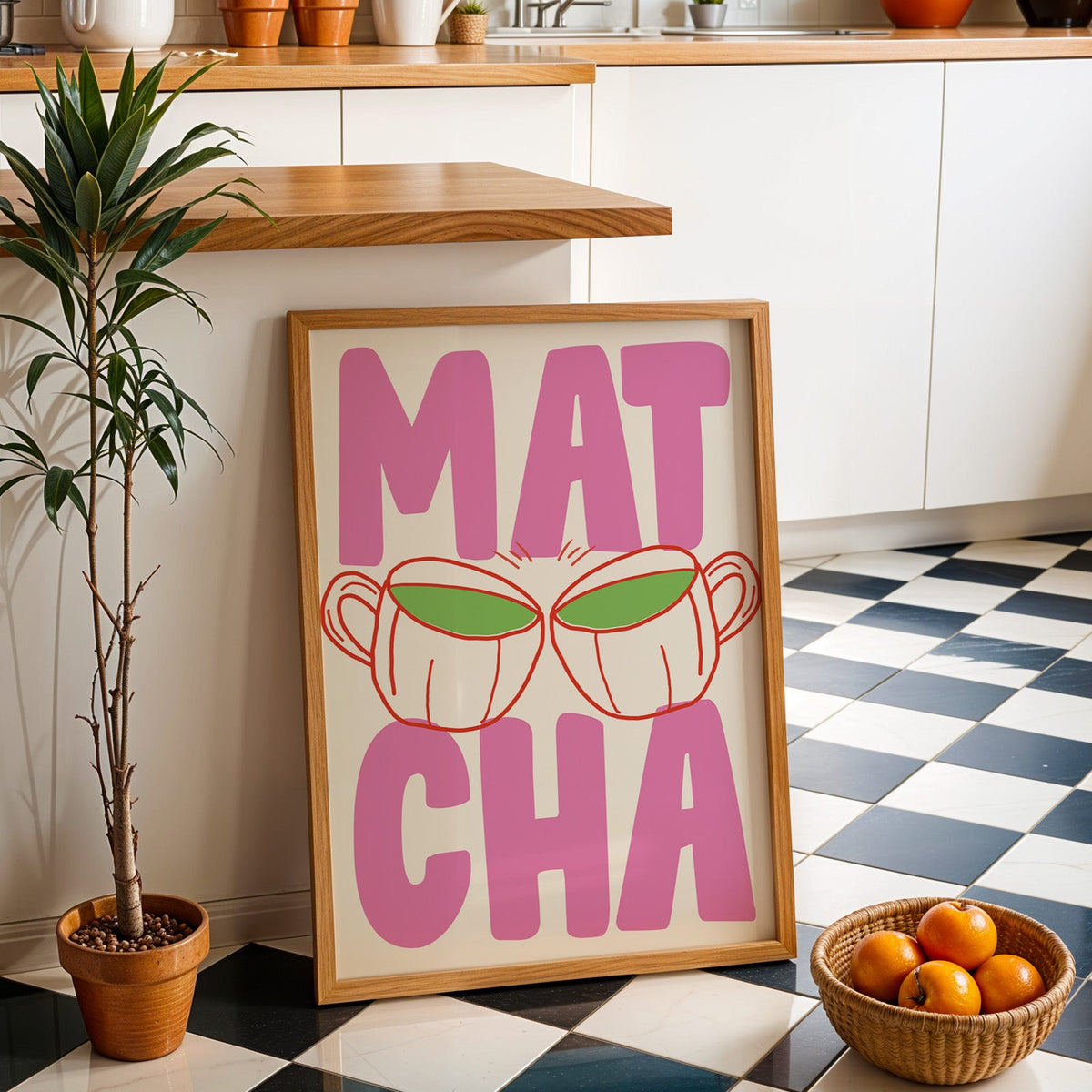 Matcha two cups print in an oak frame by a kitchen island and checkered floor