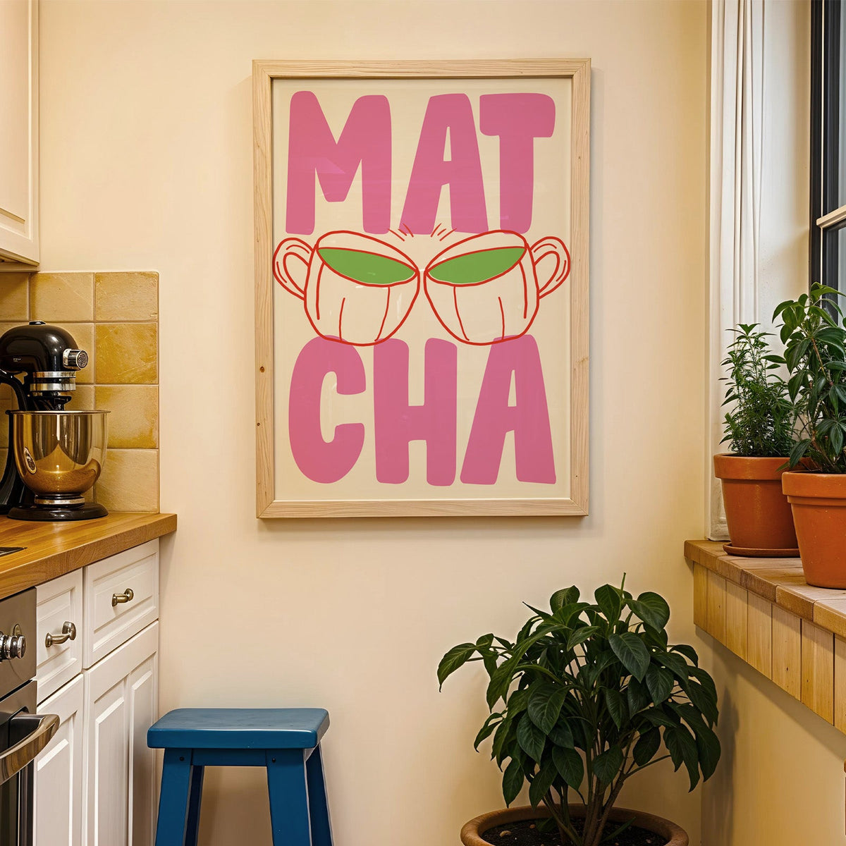 Matcha two cups print in a wood frame on a yellow tiled kitchen wall