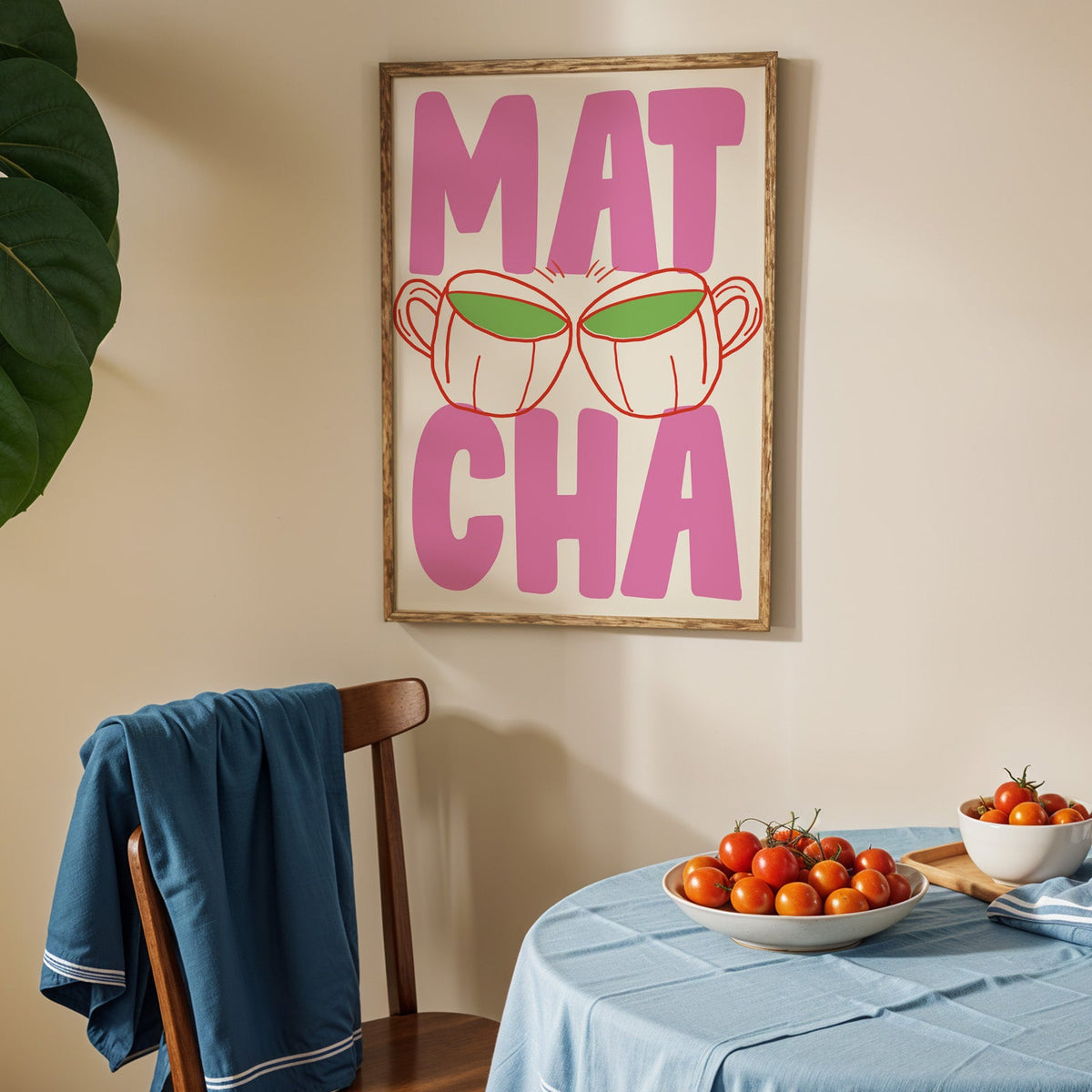 Matcha two cups print in an oak frame above a blue linen table with ripe tomatoes