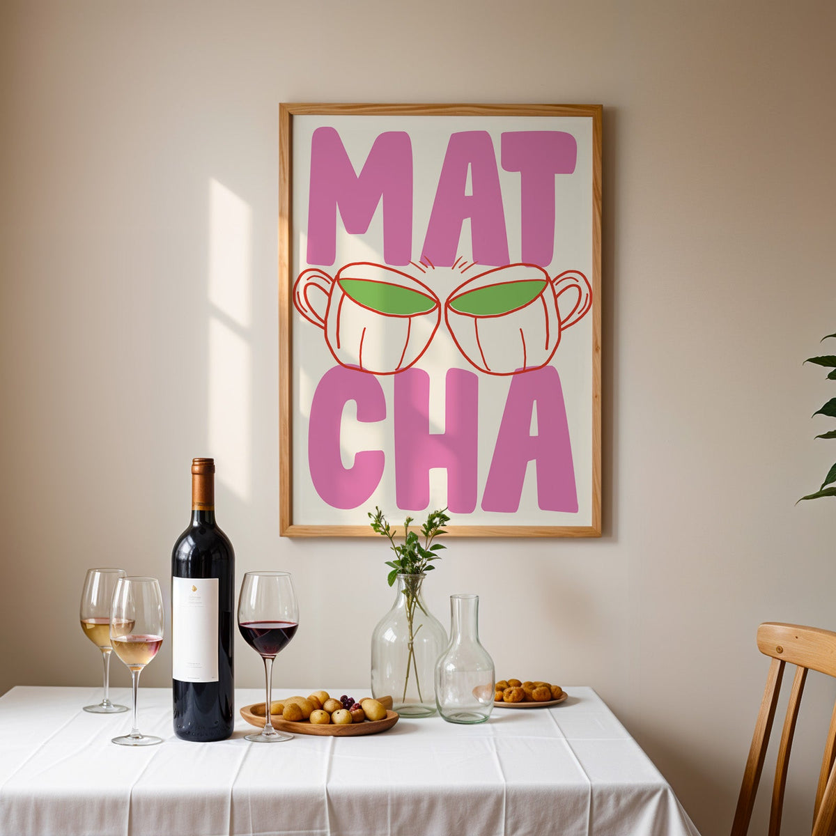 Matcha two cups print in an oak frame above a table laid with red wine and glasses