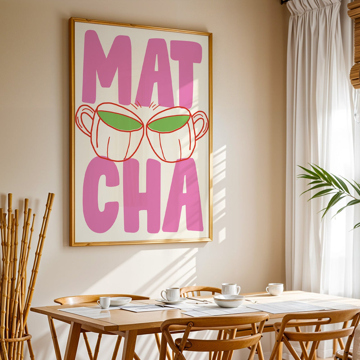 Matcha two cups print in a gold frame above a sunlit breakfast table