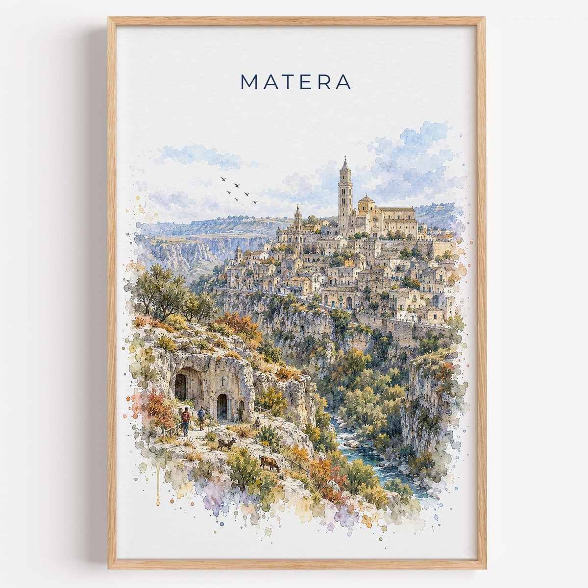 Matera watercolor print in a light oak frame on a plain white wall