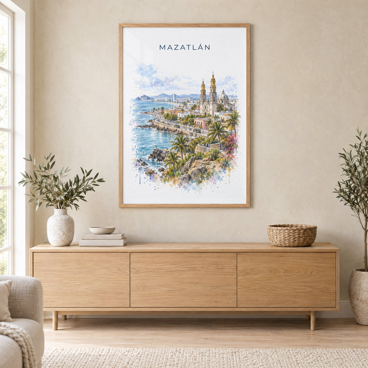 Mazatlan watercolor print in an oak frame above a light wood sideboard in a Scandinavian living room