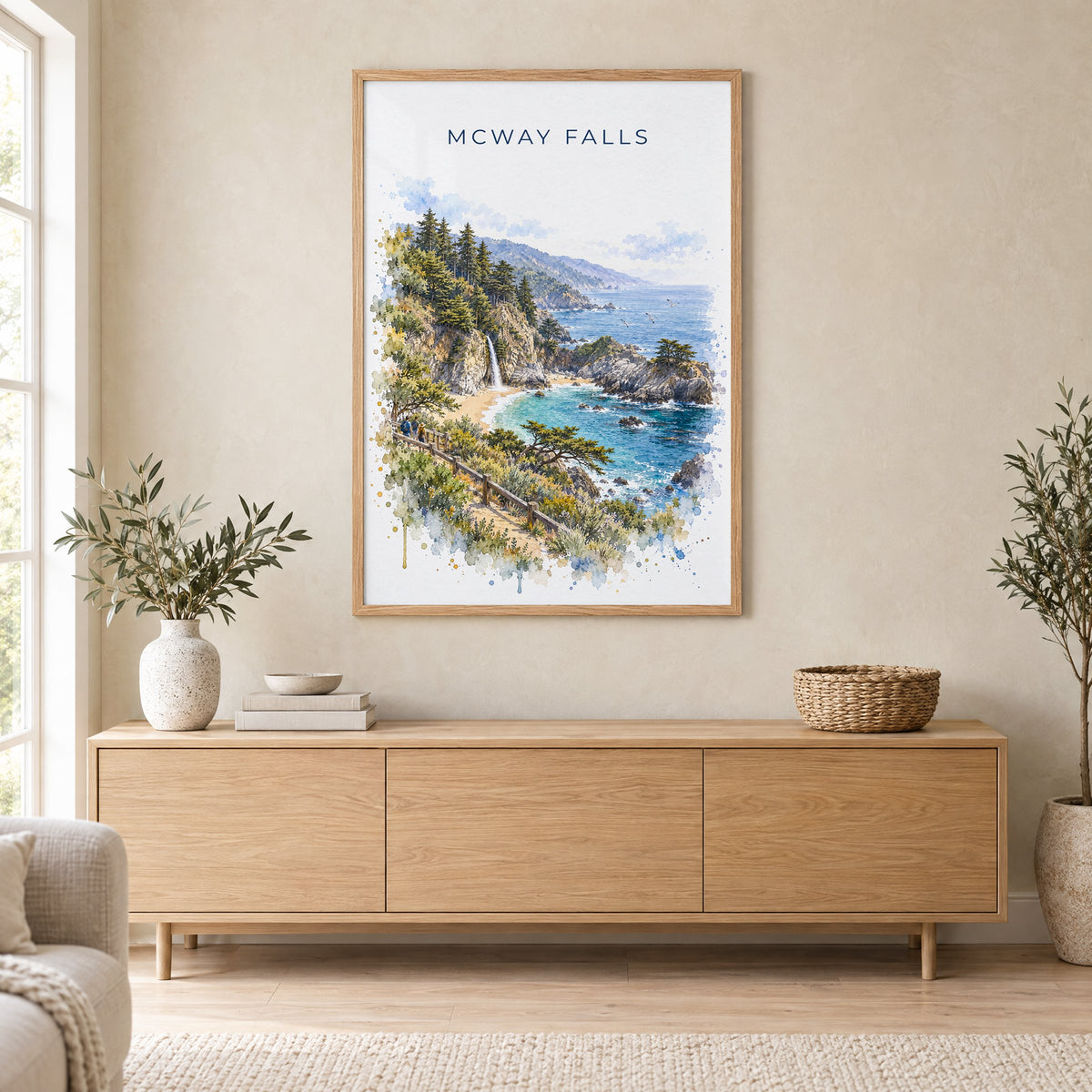 McWay Falls watercolor print in an oak frame above a light wood sideboard in a Scandinavian living room