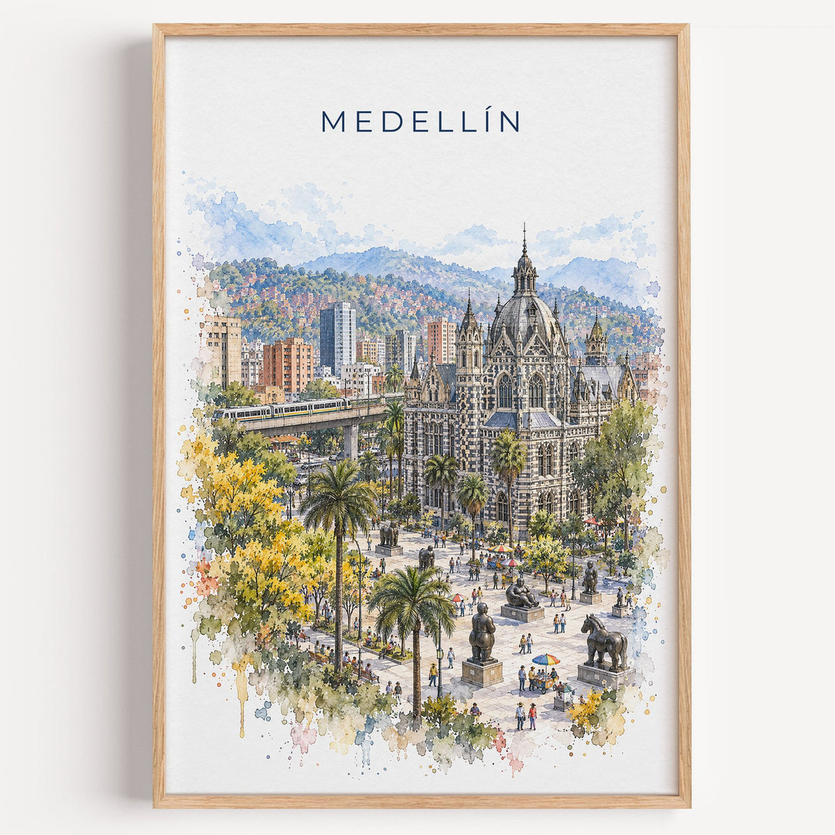 Medellín watercolor print in a light oak frame on a plain white wall