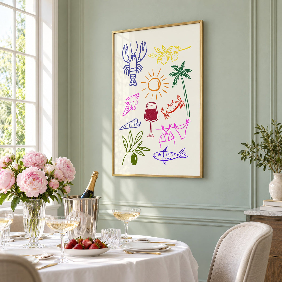 Mediterranean summer doodles lobster and wine print in a brass frame on a sage wall above a brunch table with champagne and peonies, seen at an angle