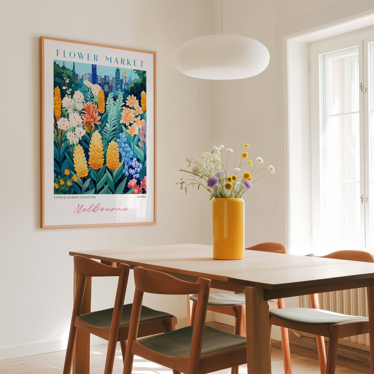 Melbourne flower market print in an oak frame above a dining table with a yellow vase and white pendant light