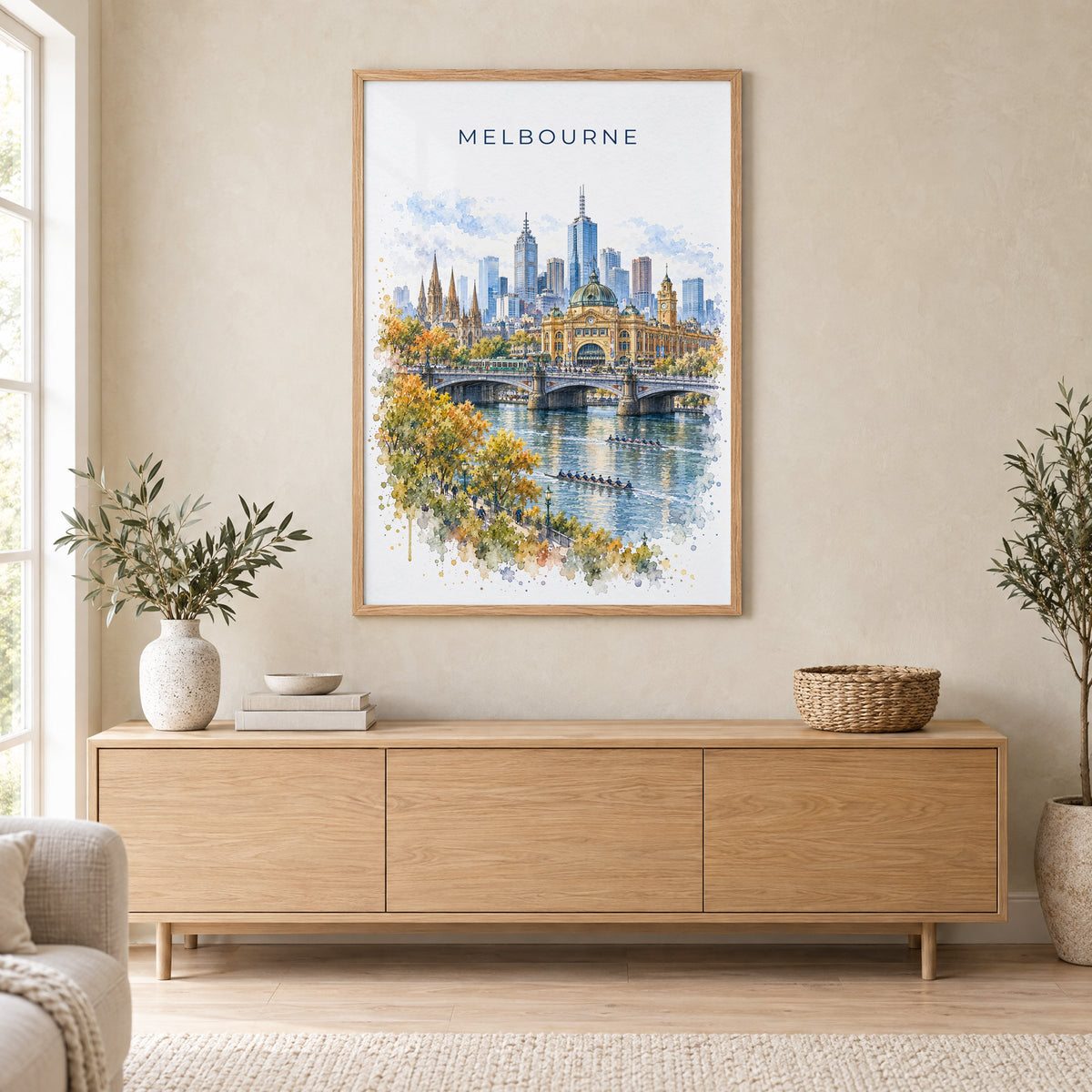 Melbourne watercolor print in an oak frame above a light wood sideboard in a Scandinavian living room