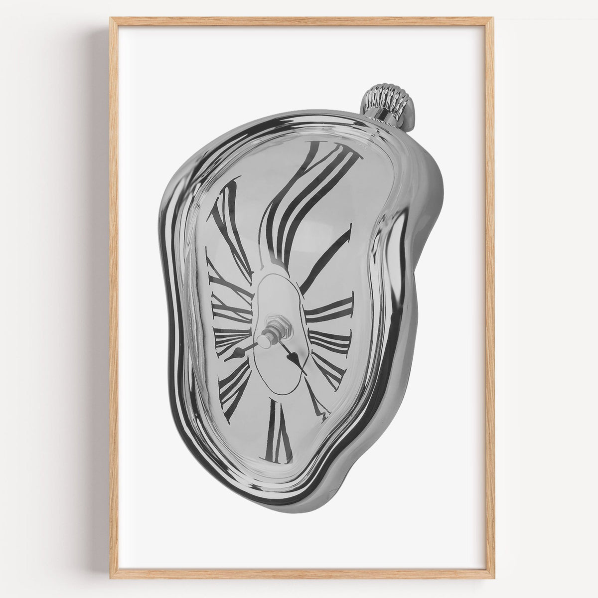 Melting silver clock with Roman numerals print in a light oak frame on a plain white wall