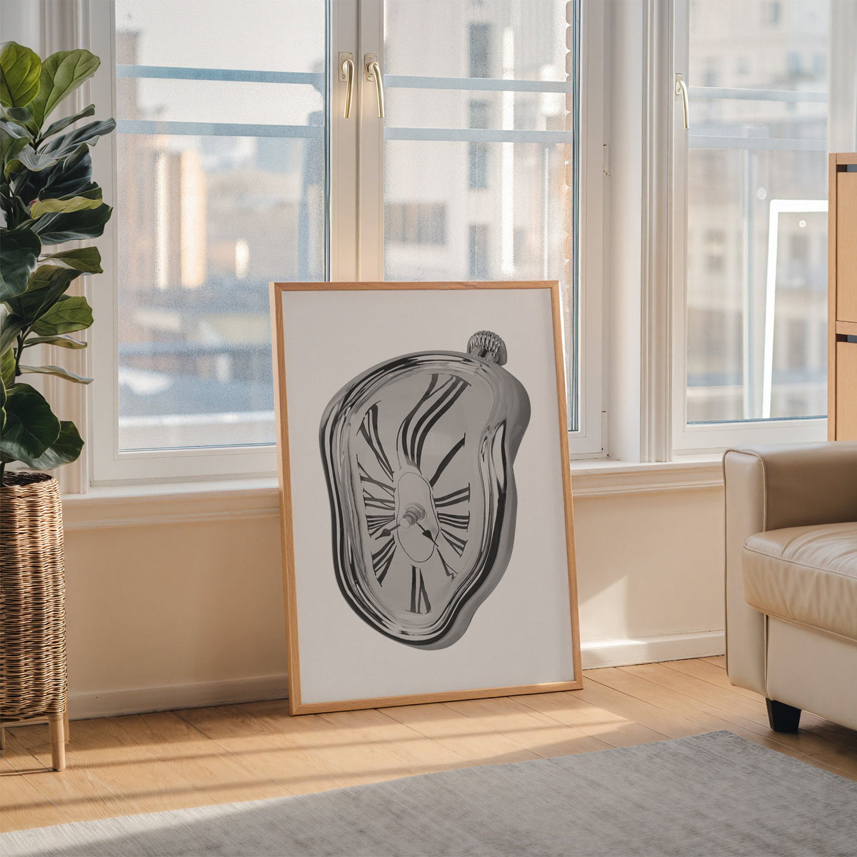 Melting silver clock with Roman numerals print in an oak frame leaning on the floor beside a fiddle leaf fig