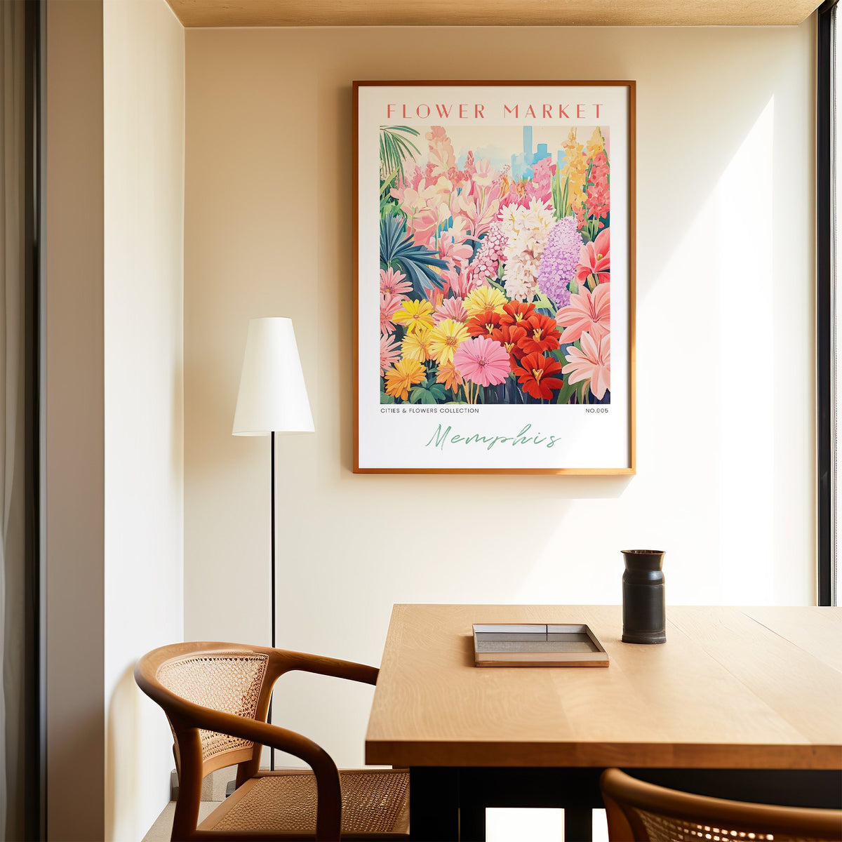 Memphis flower market print in an oak frame above a dining table and cane chair