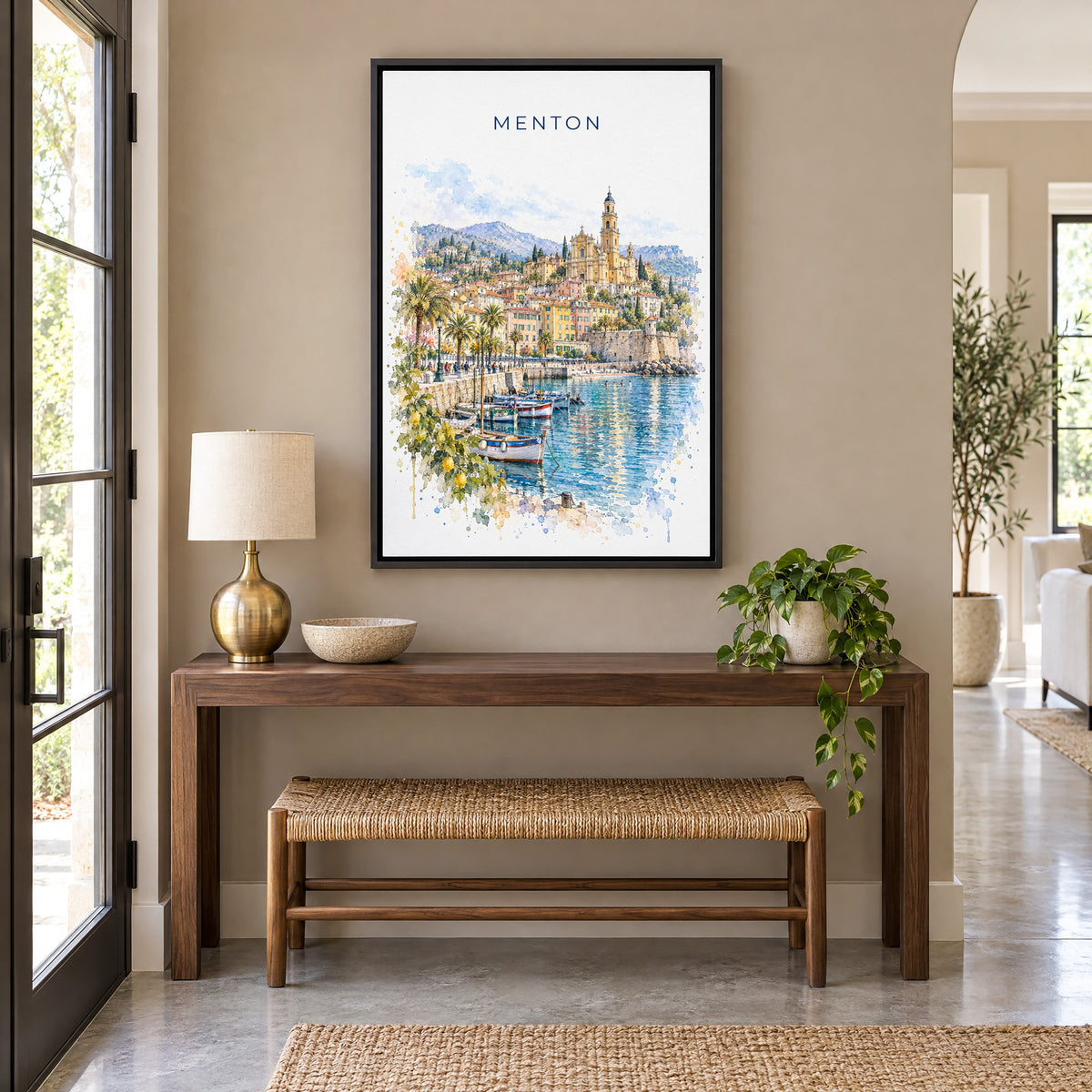 Menton watercolor print as a black floater canvas above a walnut console and woven bench in an entryway