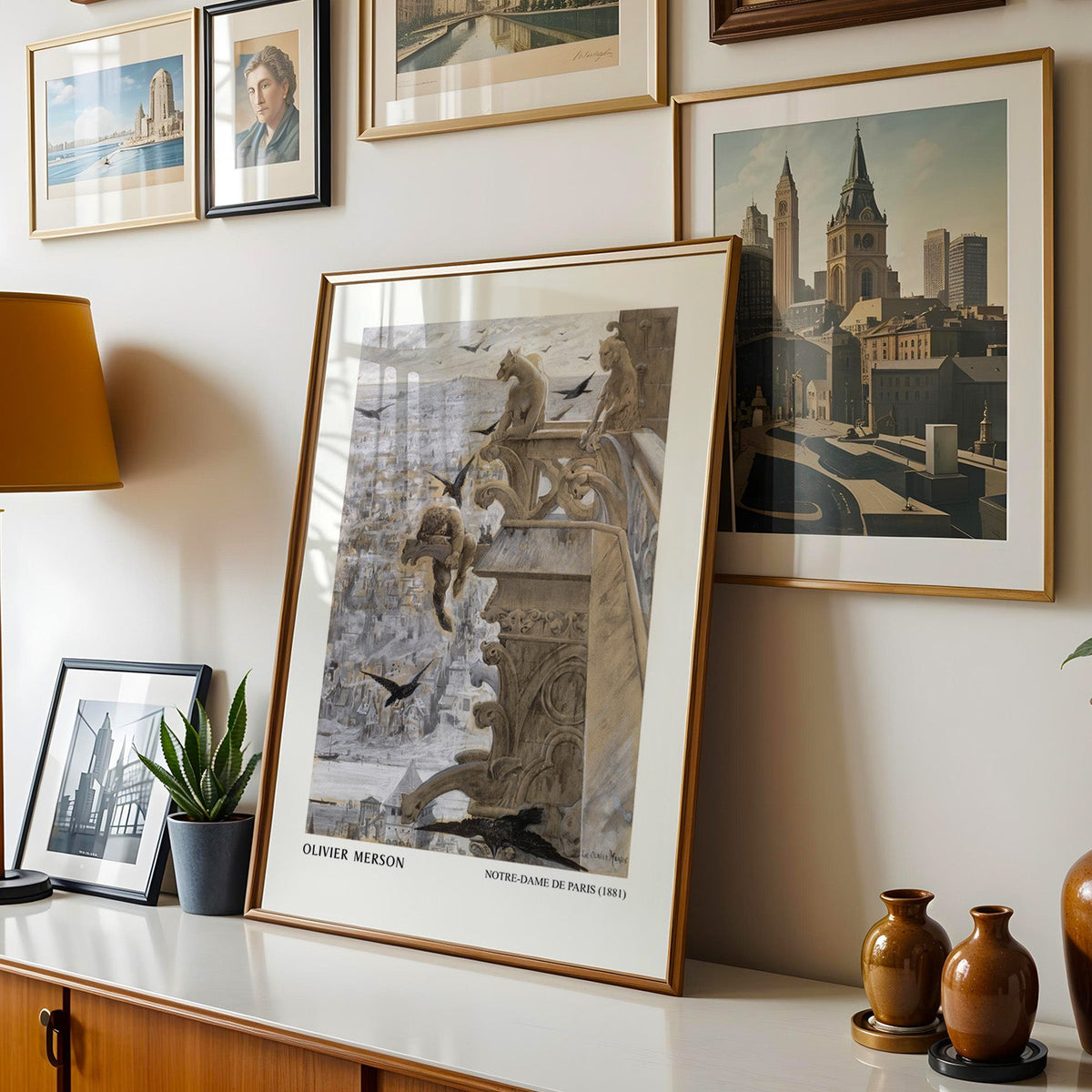 Paris print shown in a gold frame leaning on a sideboard in a gallery wall