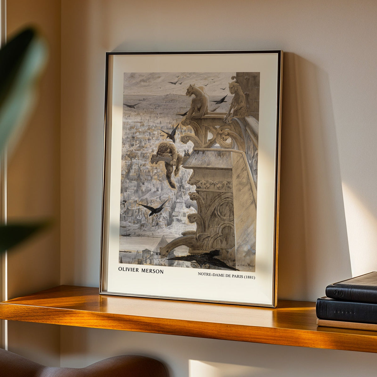 Gargoyle print in a black frame on a walnut shelf in warm evening light