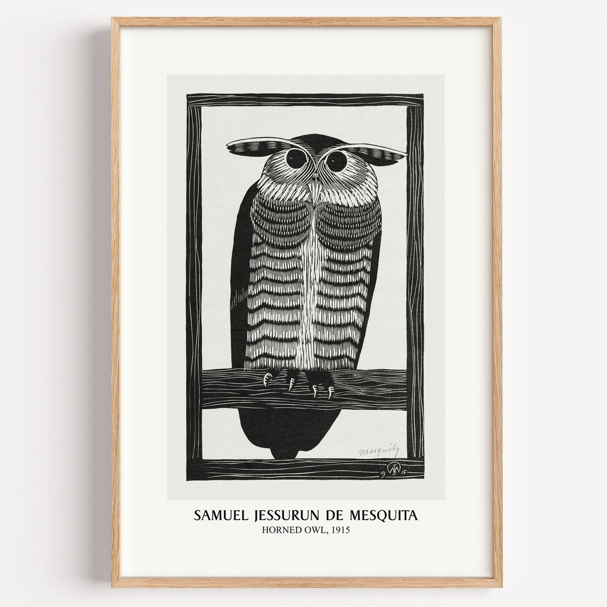 Mesquita Horned Owl woodcut print in a light oak frame on a plain white wall