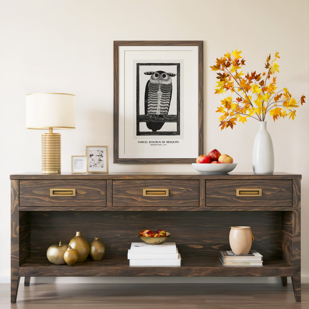 Horned Owl print in a walnut frame above a console with autumn branches