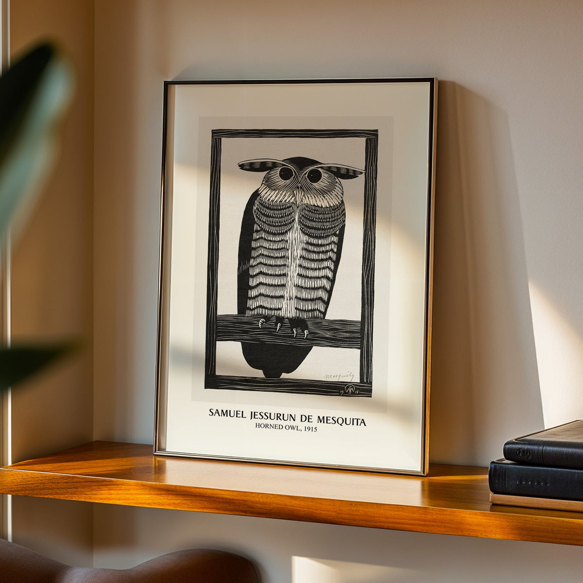 Owl print in a black frame on a walnut shelf in warm evening light