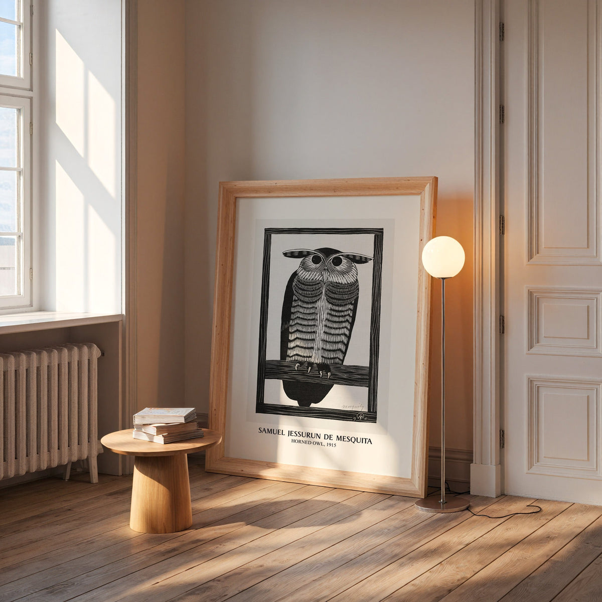 Horned Owl print in a wide pine frame leaning by a sunlit window