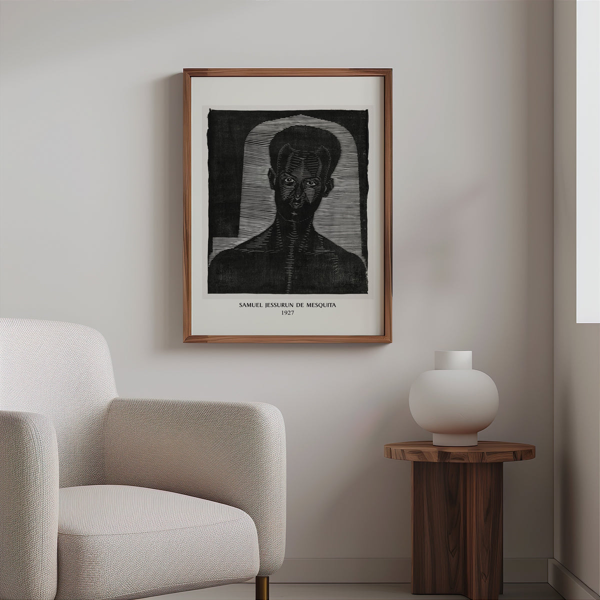 Black and white woodcut print in a slim walnut frame above a bouclé armchair