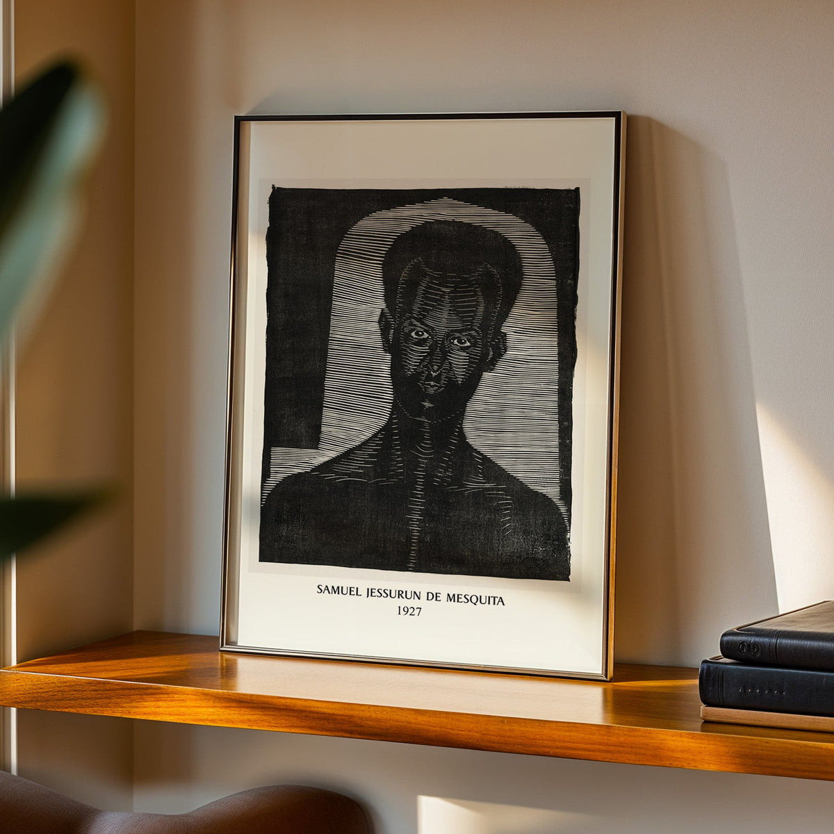 Mesquita woodcut in a black frame on a walnut shelf in warm evening light