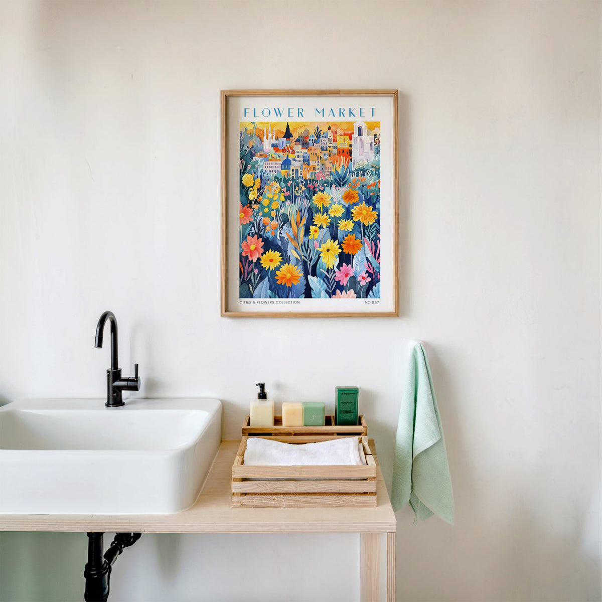Mexico flower market print in an oak frame above a white bathroom sink with folded towels