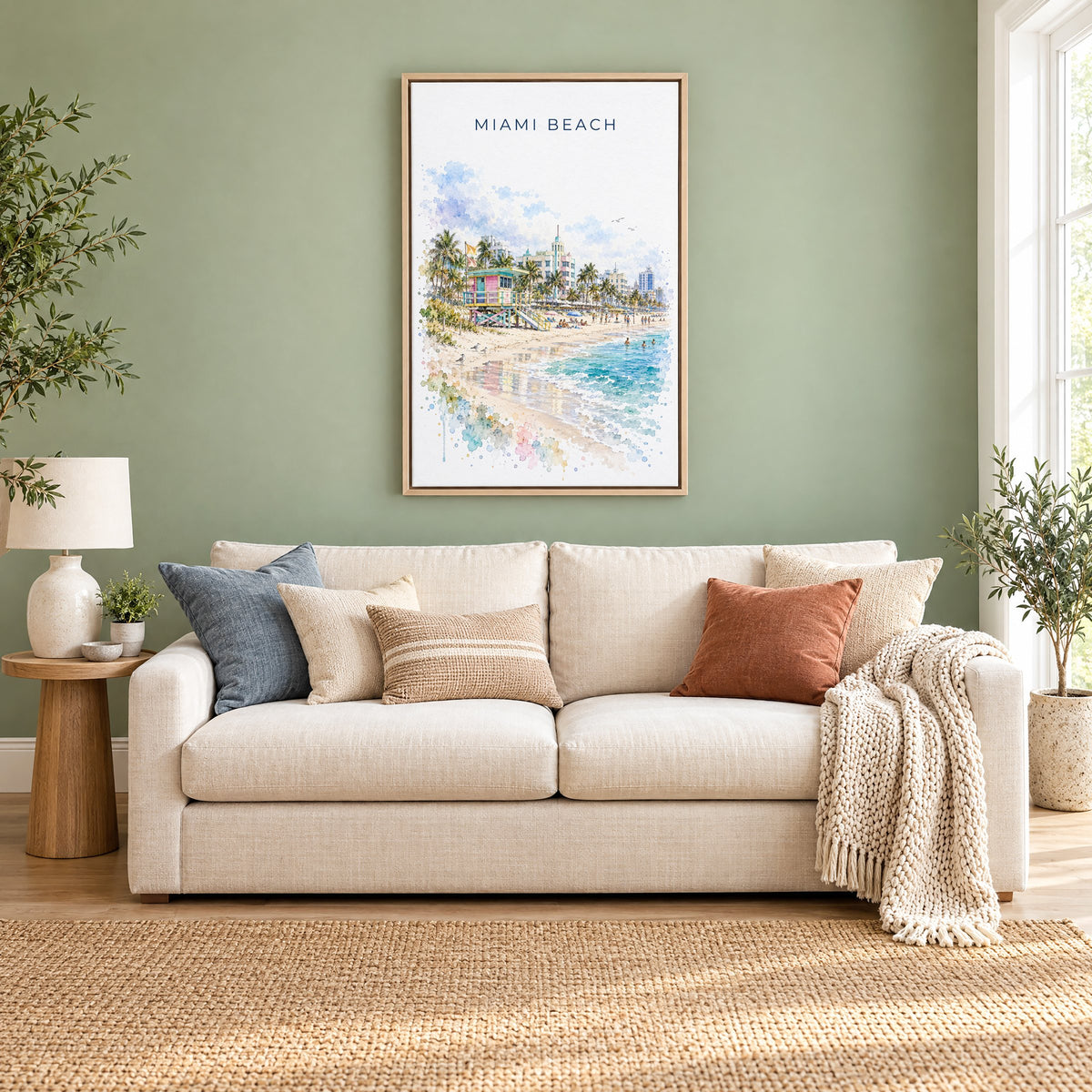 Miami Beach watercolor print as a natural floater canvas above a cream linen sofa on a sage green wall
