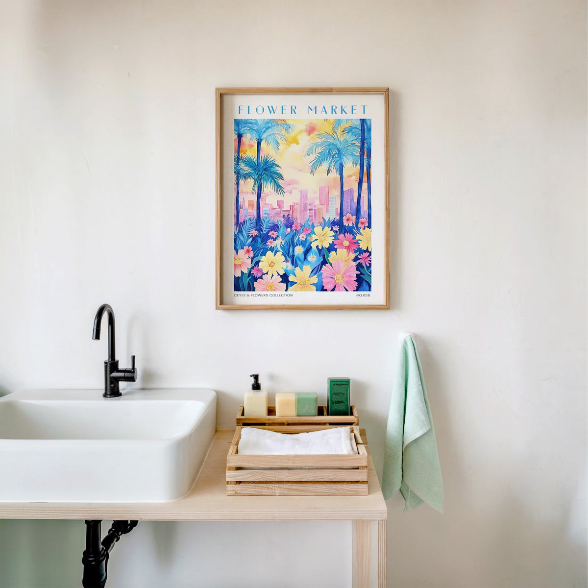 Miami flower market print in an oak frame above a white bathroom sink with folded towels